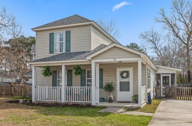 view of front facade featuring covered porch and a front yard