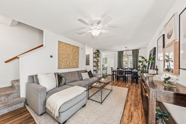 living room featuring electric panel, ceiling fan, and dark wood-type flooring