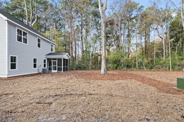 view of yard with a sunroom and cooling unit