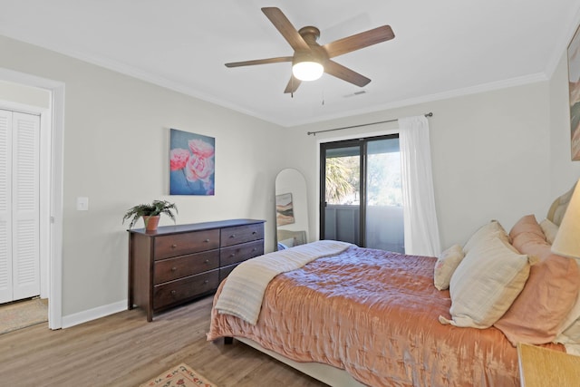 bedroom with visible vents, crown molding, baseboards, and wood finished floors