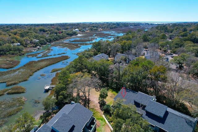 aerial view featuring a view of trees and a water view