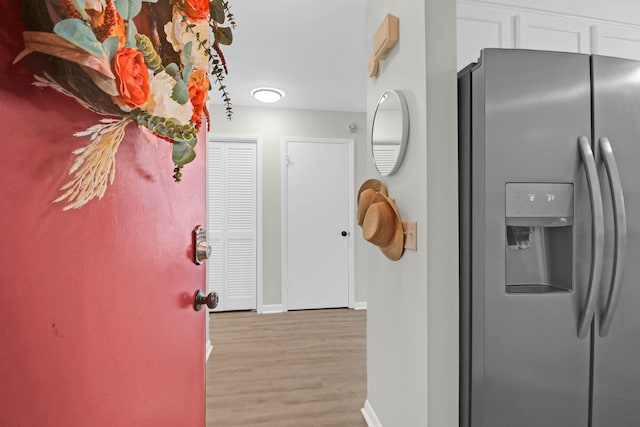 interior space featuring light wood finished floors and baseboards