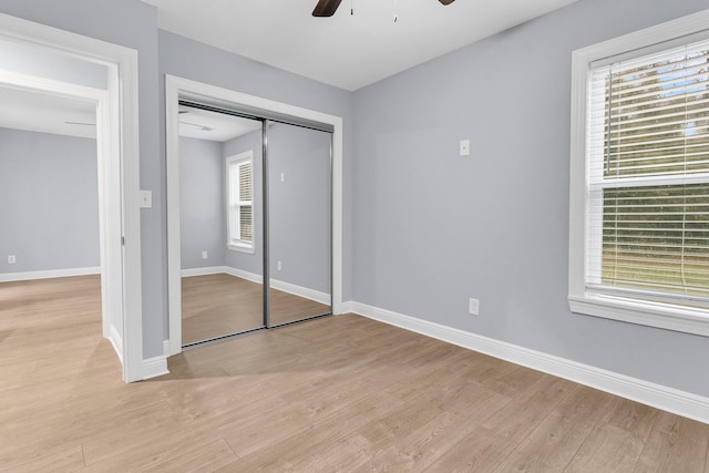 unfurnished bedroom featuring light wood-type flooring, a closet, and ceiling fan