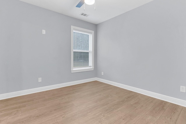 empty room with ceiling fan and light hardwood / wood-style floors