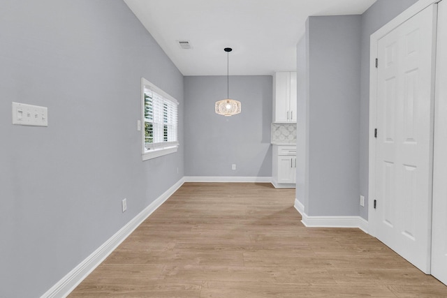 unfurnished dining area with light hardwood / wood-style floors