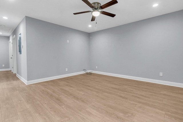 empty room with ceiling fan and light hardwood / wood-style floors