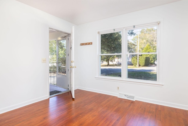 interior space with visible vents, baseboards, and wood finished floors