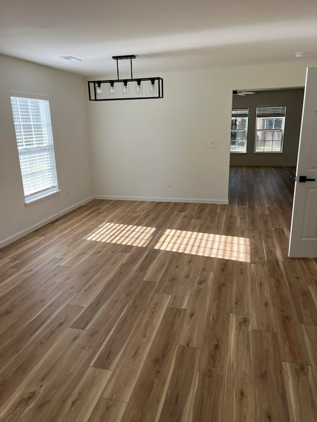 unfurnished dining area with dark wood-type flooring