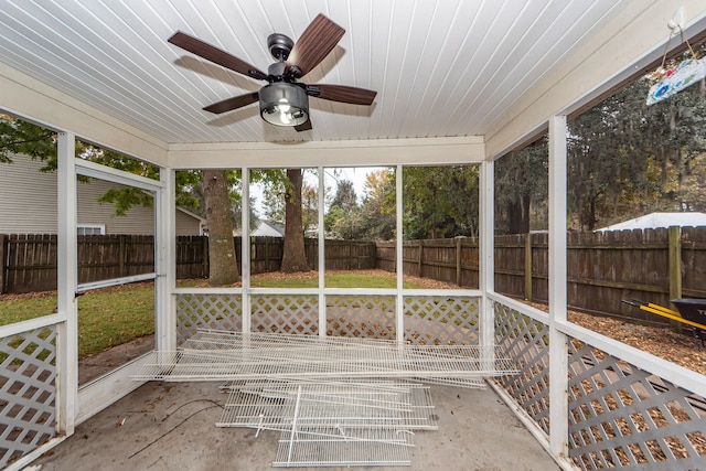 unfurnished sunroom featuring plenty of natural light, ceiling fan, and wooden ceiling