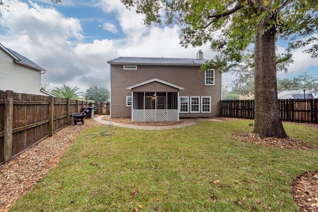 back of house featuring a sunroom and a yard