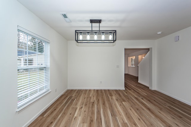 unfurnished dining area with hardwood / wood-style floors