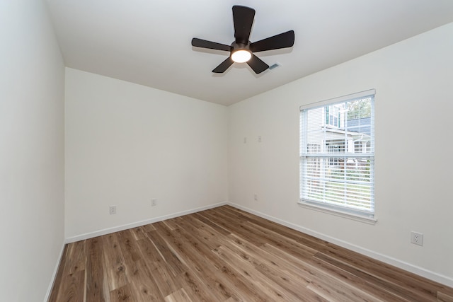 empty room with ceiling fan and wood-type flooring