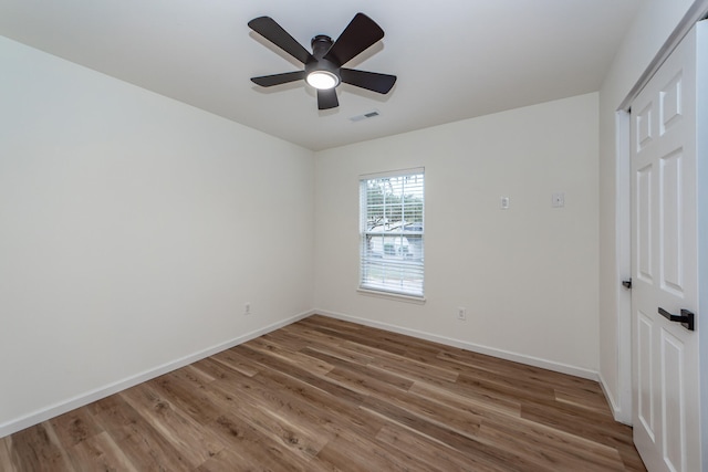 unfurnished room with ceiling fan and wood-type flooring