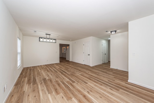 empty room with light hardwood / wood-style flooring