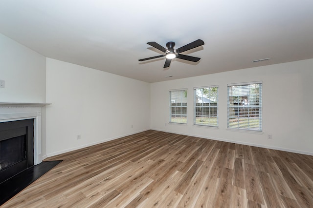 unfurnished living room with ceiling fan and light hardwood / wood-style flooring