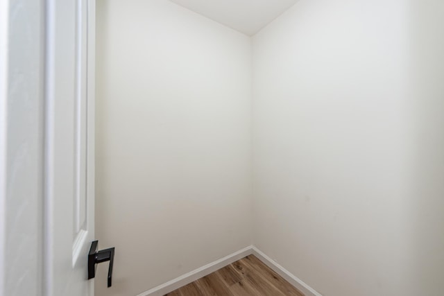 laundry area with hardwood / wood-style flooring