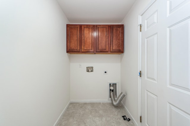 washroom with electric dryer hookup, hookup for a washing machine, and cabinets