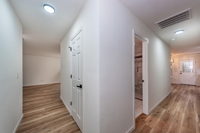 hallway with light hardwood / wood-style flooring