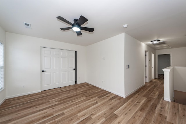 unfurnished room with ceiling fan and light wood-type flooring