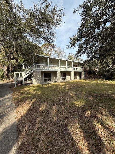 back of property featuring a lawn