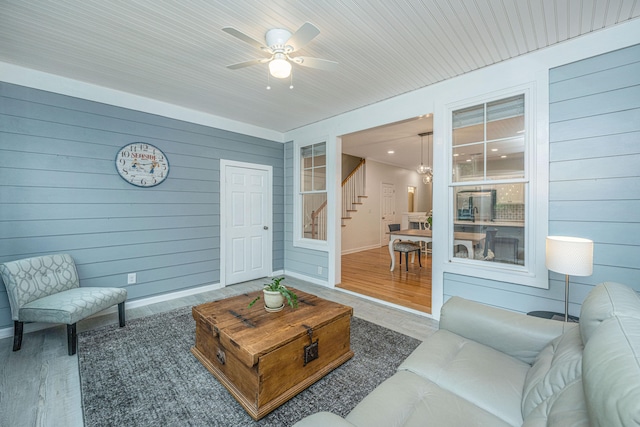 living room with wood walls and hardwood / wood-style floors