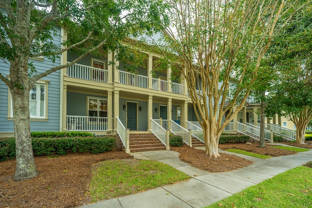 view of front of home featuring covered porch and a balcony