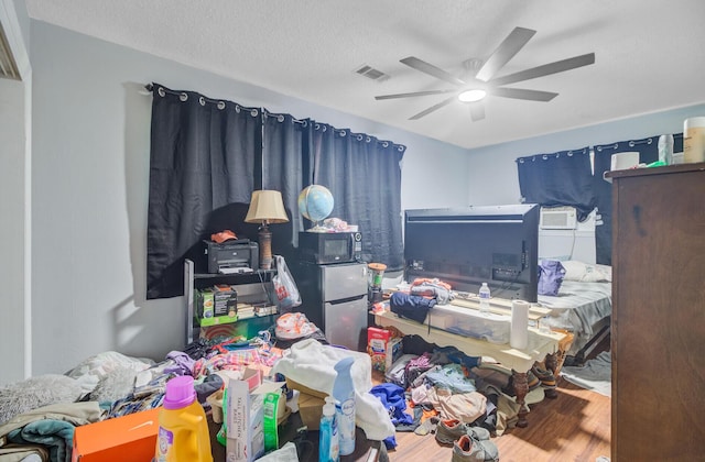 7074 W Constellation Dr, North Charleston, SC 29418 - bedroom featuring wood finished floors, ceiling fan, a textured ceiling, and cooling unit