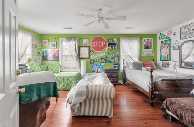 bedroom with ceiling fan and dark hardwood / wood-style flooring