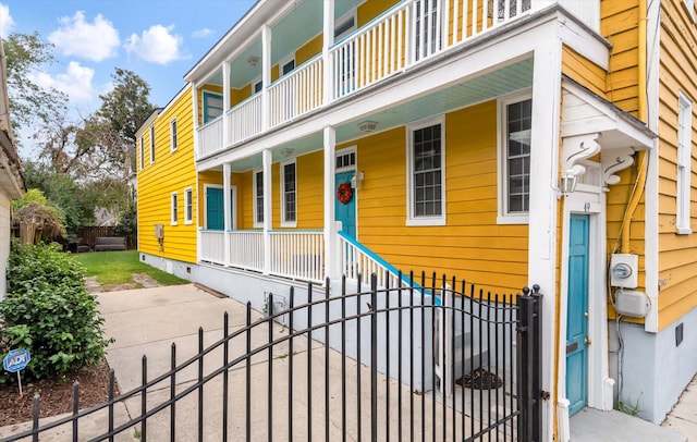 view of front of property with a porch and a balcony