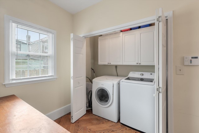 laundry area featuring cabinets, independent washer and dryer, and light wood-type flooring