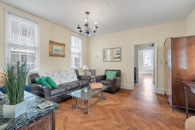 living room featuring parquet flooring and a chandelier