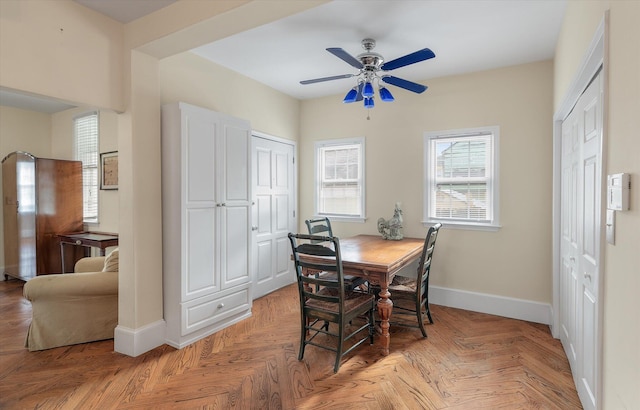 dining space with light parquet flooring and ceiling fan