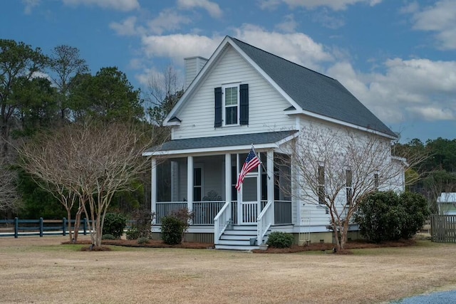 view of front of property with covered porch and a front yard