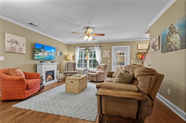 1583 Southwick Dr, Johns Island, SC 29455 - living room with a glass covered fireplace, ornamental molding, wood finished floors, a ceiling fan, and baseboards