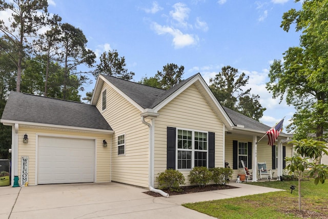 1583 Southwick Dr, Johns Island, SC 29455 - view of front of property with concrete driveway, a garage, covered porch, and a shingled roof