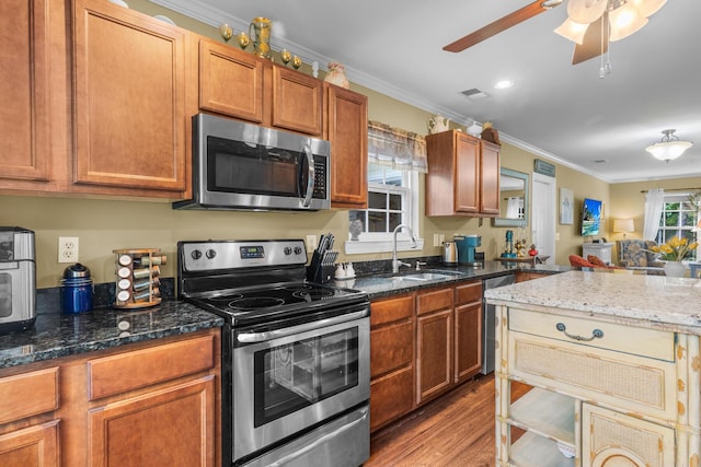 1583 Southwick Dr, Johns Island, SC 29455 - kitchen featuring appliances with stainless steel finishes, a sink, wood finished floors, ceiling fan, and ornamental molding