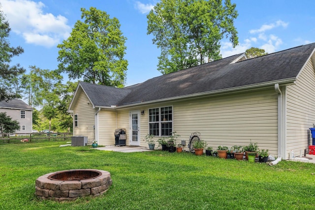 1583 Southwick Dr, Johns Island, SC 29455 - rear view of house with central air condition unit, a patio, an outdoor fire pit, and a shingled roof