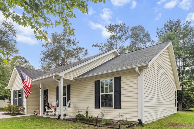 1583 Southwick Dr, Johns Island, SC 29455 - ranch-style house featuring a porch, a front yard, and a shingled roof