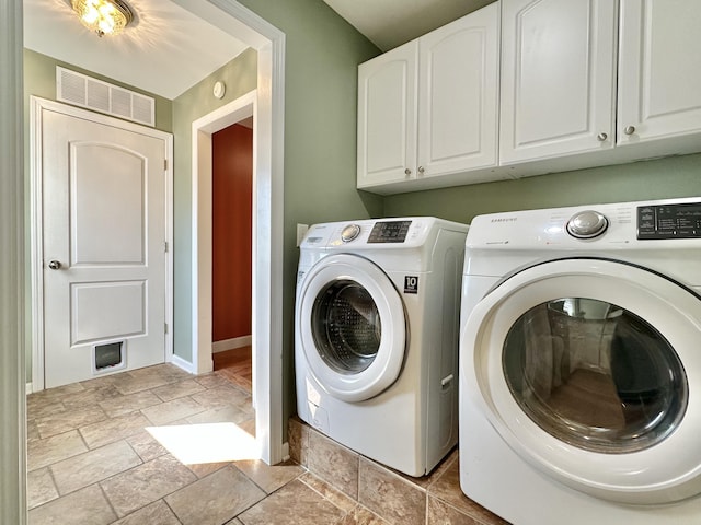 clothes washing area with cabinets and independent washer and dryer