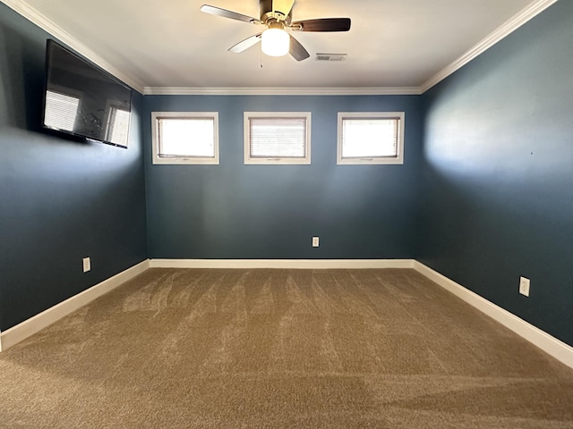 unfurnished room with ceiling fan, ornamental molding, a healthy amount of sunlight, and carpet flooring