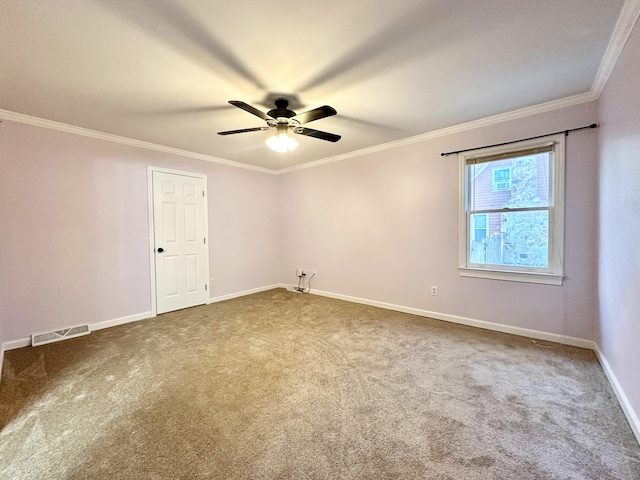 spare room with ornamental molding, carpet flooring, and ceiling fan