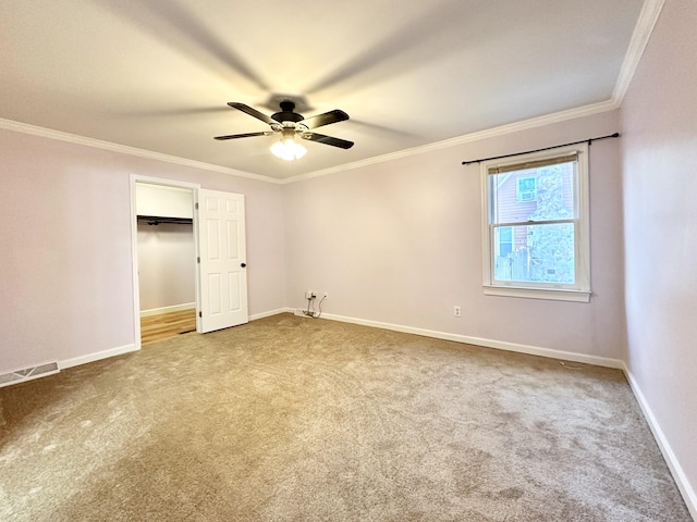 unfurnished bedroom with crown molding, carpet floors, and ceiling fan