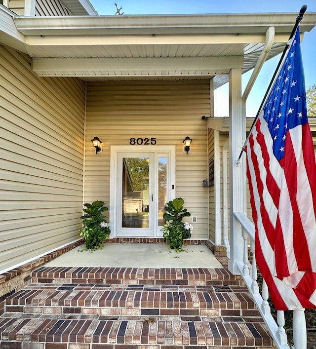 doorway to property featuring covered porch