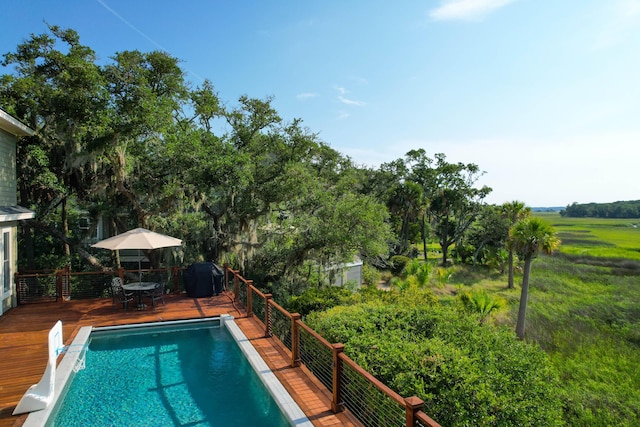 view of pool with a wooden deck and a grill