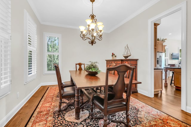 dining room featuring ornamental molding, dark wood-type flooring, and a chandelier