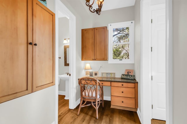 office space featuring dark hardwood / wood-style flooring and a notable chandelier