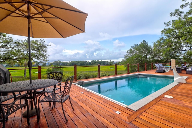 view of swimming pool with a deck