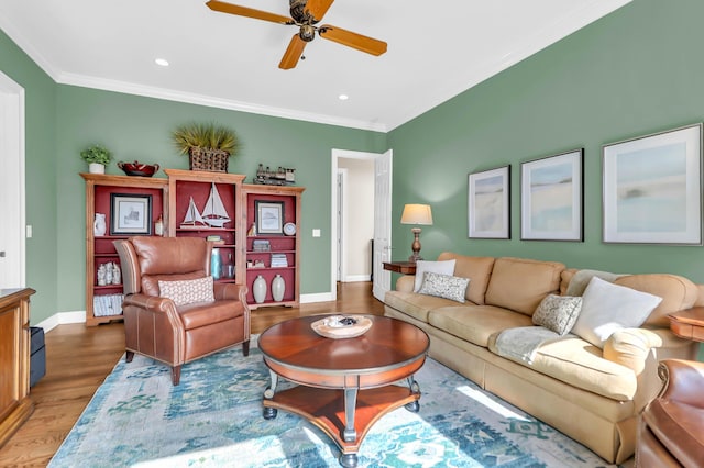 living room featuring hardwood / wood-style floors, ornamental molding, and ceiling fan