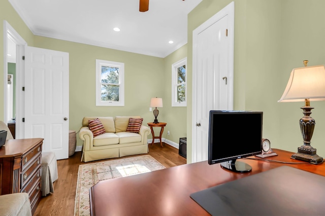 office space with crown molding, ceiling fan, and light hardwood / wood-style flooring