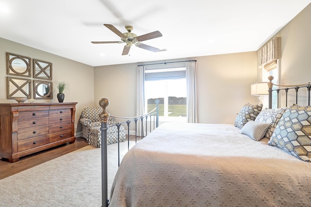 bedroom with ceiling fan and hardwood / wood-style floors